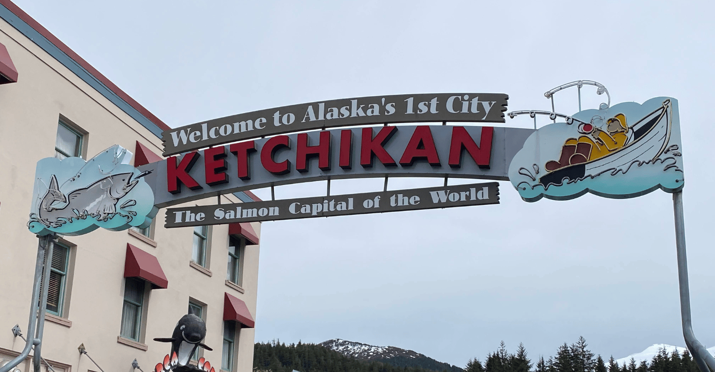 The welcome to ketchikan sign on mission street on a cloudy day
